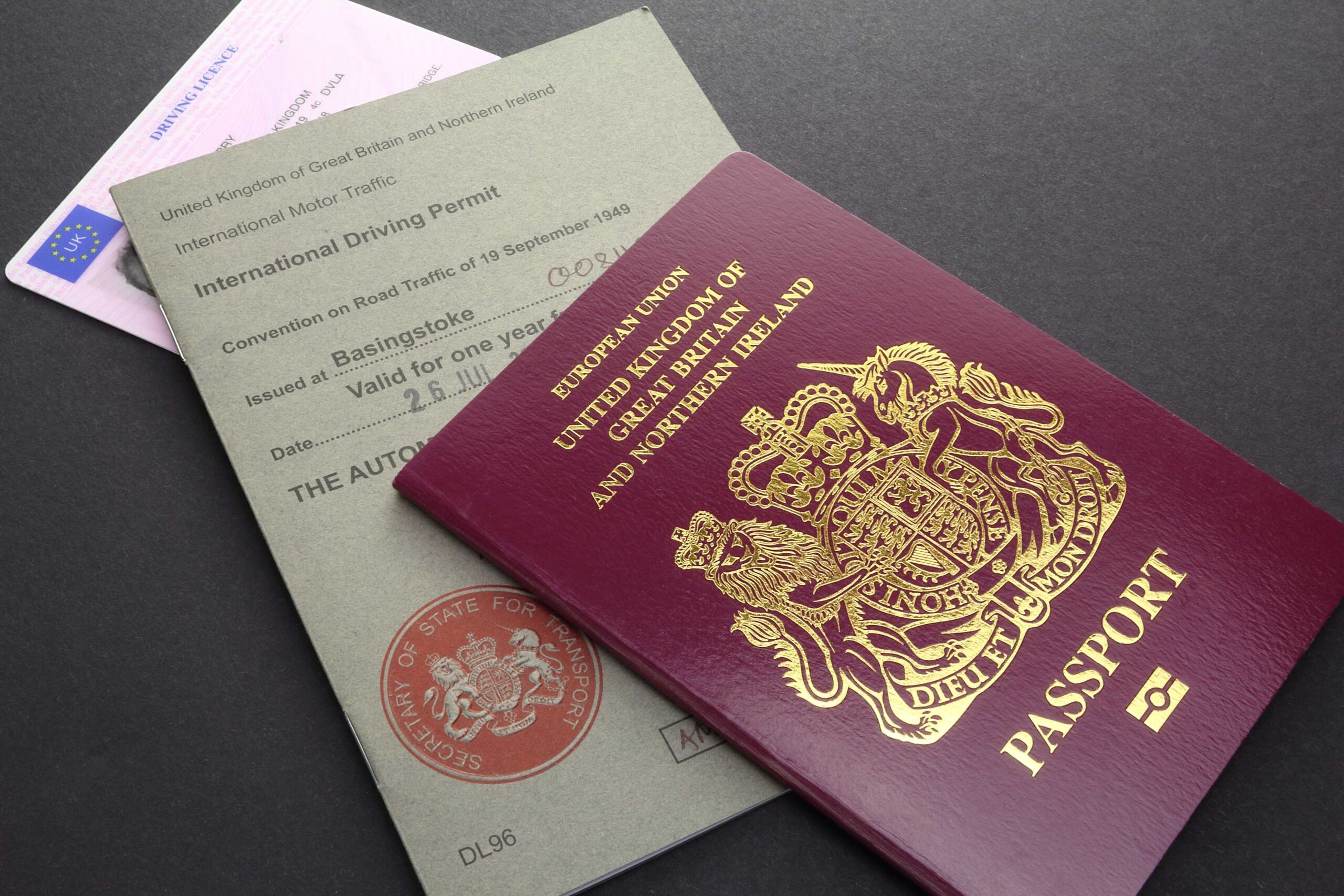Close up of British passport and International Driving Permit to underscore importance of car rental excess insurance.